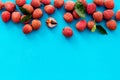 Lychee frame. Exotic asian fruits on blue background top-down copy space Royalty Free Stock Photo