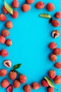 Lychee frame. Exotic asian fruits on blue background top-down copy space Royalty Free Stock Photo