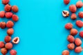 Lychee frame. Exotic asian fruits on blue background top-down copy space Royalty Free Stock Photo