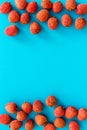 Lychee frame. Exotic asian fruits on blue background top-down copy space Royalty Free Stock Photo