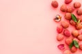 Lychee frame. Exotic asian fruits on pink background top-down copy space Royalty Free Stock Photo