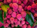 Lychee fruits background, Fresh lychee and peeled showing the red skin and white flesh with green leaf.Sell on the market in Thail Royalty Free Stock Photo