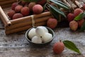 Lychee with leaves on gray background. Tropical fruit. Royalty Free Stock Photo
