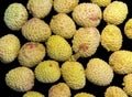 Lychee- small rounded fruit with sweet white scented flesh, a large central stone, and a thin rough skin