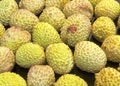 Lychee- small rounded fruit with sweet white scented flesh, a large central stone, and a thin rough skin-