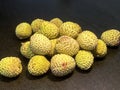 Lychee- small rounded fruit with sweet white scented flesh, a large central stone, and a thin rough skin