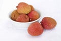 Lychee in a white bowl on the table Royalty Free Stock Photo