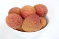 Lychee in a white bowl on the table Royalty Free Stock Photo
