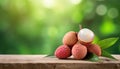 Lychee on wood with a blurred green background