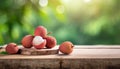 Lychee on wood with a blurred green background