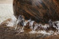 Rotating stone in water fountain in the center