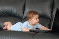 Lying baby with laptop Royalty Free Stock Photo