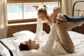 Lying on bed father play raise up daughter on hands Royalty Free Stock Photo