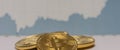 lying bitcoins with a fluctuating stock market chart middle panorama Royalty Free Stock Photo