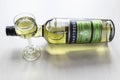 Lying bottle of green Chartreuse liqueur and glass