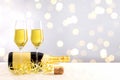 champagne bottle with filled glasses in front of a golden bokeh background Royalty Free Stock Photo