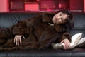 Lying female in a mink coat