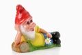 Lying garden gnome holding flower Royalty Free Stock Photo