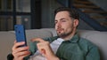 Lying guy typing smartphone couch looking screen at house environment closeup Royalty Free Stock Photo