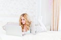 Lying on her bed using laptop at home in the bedro Royalty Free Stock Photo