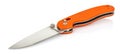 Lying open folding pocket knife with matte blade and textured orange composite plastic cover plates on steel handle isolated on