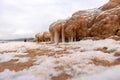 lying pieces of ice on the seashore, icicles of different sizes, textures of sand and ice in the dunes Royalty Free Stock Photo