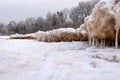 lying pieces of ice on the seashore, icicles of different sizes, textures of sand and ice in the dunes Royalty Free Stock Photo