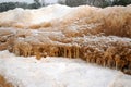 lying pieces of ice on the seashore, icicles of different sizes, textures of sand and ice in the dunes Royalty Free Stock Photo