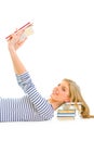 Lying teengirl with resting head on schoolbook Royalty Free Stock Photo