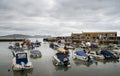 LYME REGIS, DORSET, UK - MAY 7 2023: View of the Cobb and harbour with boats. Tide in.