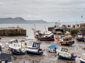 LYME REGIS, DORSET, UK - MAY 7 2023: View of the Cobb and harbour with boats. Tide in.