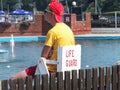 Lymington, England - July 2013: A lifeguard watches bathers in public swimming pool Royalty Free Stock Photo