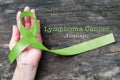 Lymphoma Cancer Awareness Lime Green ribbon color on helping hand with clipping path