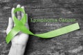 Lymphoma Cancer Awareness, Lime Green ribbon on helping hand clipping path