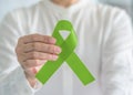 Lymphoma Cancer and mental health awareness Lime Green ribbon symbolic bow for raising support and helping patient living