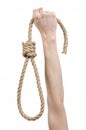 Lynching and suicide theme: man's hand holding a loop of rope for hanging on white isolated background