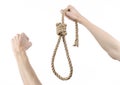 Lynching and suicide theme: man's hand holding a loop of rope for hanging on white isolated background Royalty Free Stock Photo