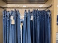 Lynnwood, WA USA - circa March 2023: Close up view of jeans for sale on a clothing rack inside a Nordstrom store