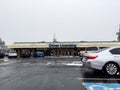 Lynnwood, WA USA - circa November 2022: Wide view of the entrance to the Lynnwood DMV on a snowy day