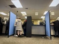 Lynnwood, WA USA - circa November 2022: Wide view of people inside the Lynnwood DMV building, updating and applying for licenses