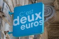 C\'est deux euros logo brand signboard and text sign on facade wall entrance shop facade market