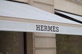 Hermes logo sign and text brand front wall entrance facade fashion shop luxury goods