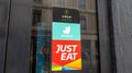 just eat deliveroo uber eats sign brand and french text logo on windows entrance restaurant