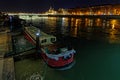 A barge on Rhone river at night with Hotel Dieu buildings in background Royalty Free Stock Photo