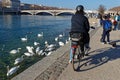 Family walks and rides of the Rhone river banks on a sunny winter afternoon