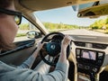 Rear view of woman driving in fast car on French autoroute highway driving a Skoda Octavia car Royalty Free Stock Photo