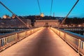 Lyon night cityscape with illuminated Courthouse and red pedestrian bridge over Saone river. Panoramic Royalty Free Stock Photo