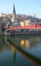 Lyon`s red bridge mirrored in the water