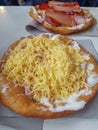 LÃÂ¡ngos is a Hungarian food speciality, a deep fried dough topped with sour cream, cheese and any other toppings. Unhealthy fast Royalty Free Stock Photo