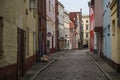 LÃÂ¼beck, Germany, September 11, 2021: Boetcherstrasse, a narrow alley near the harbor with cobblestones, historic houses, graffiti Royalty Free Stock Photo